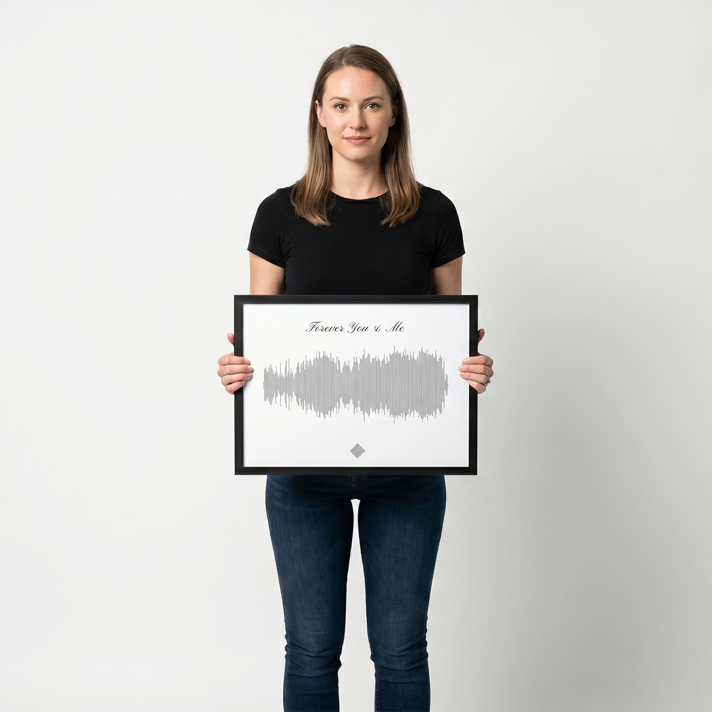 Woman holding a 16×12 framed sound wave art print to show its size