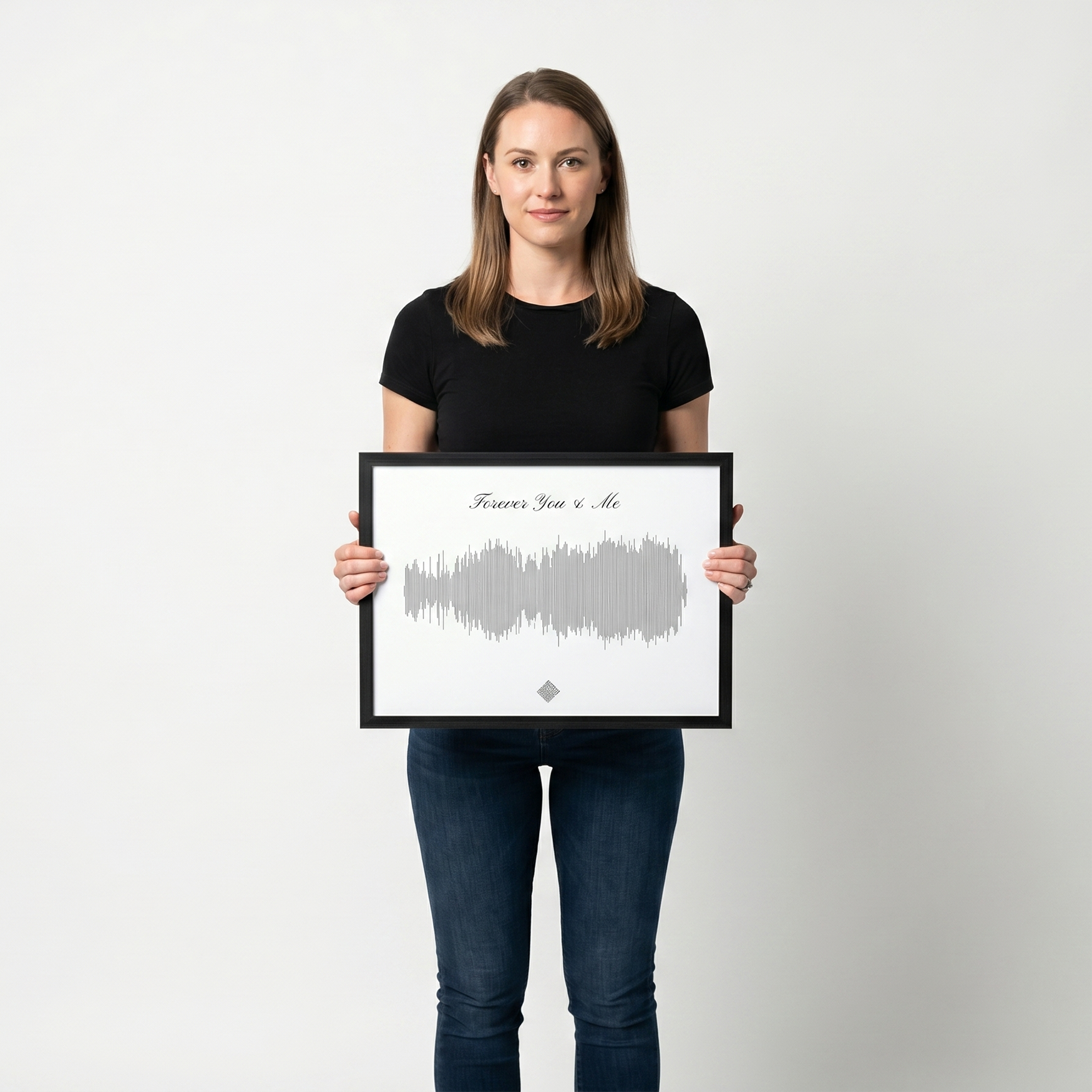 Woman holding a 16×12 framed sound wave art print to show its size
